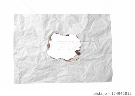 A roughly torn hole in a piece of crumpled white paper, revealing the background. A versatile design element symbolizing emptiness or revelation. On a transparent background. A roughly torn hole in a piece of crumpled white paper, revealing the background. A versatile design element symbolizing emptiness or revelation. On a transparent background. 134945813