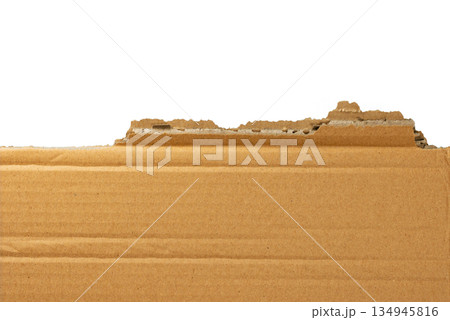 Several pieces of brown corrugated cardboard stacked together, showing various torn edges and layers. Great for a grunge or industrial design element. On a transparent background. 134945816