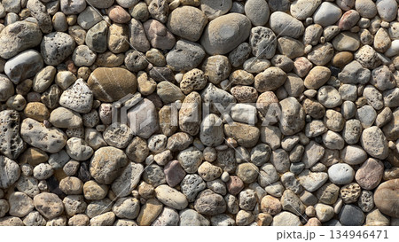 Natural river rocks forming a textured stone pattern 134946471