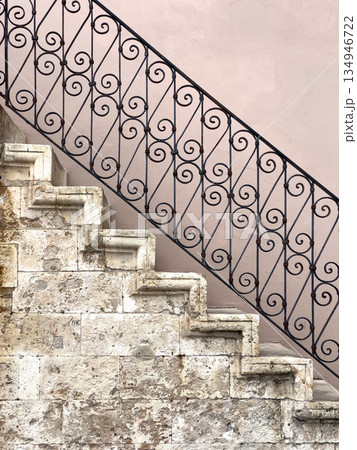 Ancient stone staircase with wrought iron railing detail Ancient stone staircase with wrought iron railing detail 134946722