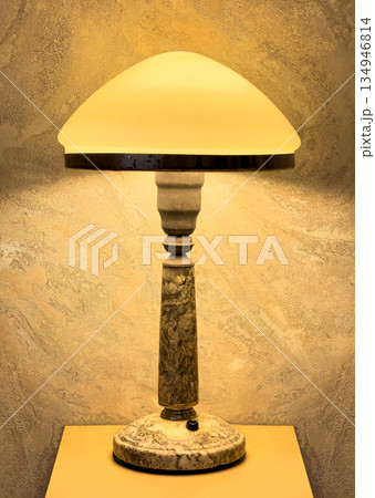 Vintage art deco marble table lamp illuminating room Vintage art deco marble table lamp illuminating room 134946814