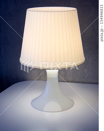 White table lamp illuminating a modern interior design 134946815