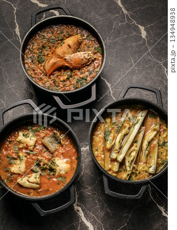 Portuguese traditional food fish soup and seafood risotto meal on restaurant table in lisbon Portuguese traditional food fish soup and seafood risotto meal on restaurant table in lisbon 134948938