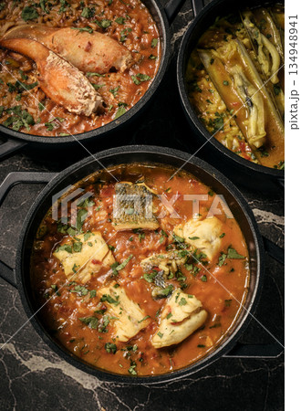 Portuguese traditional food fish soup and seafood risotto meal on restaurant table in lisbon Portuguese traditional food fish soup and seafood risotto meal on restaurant table in lisbon 134948941