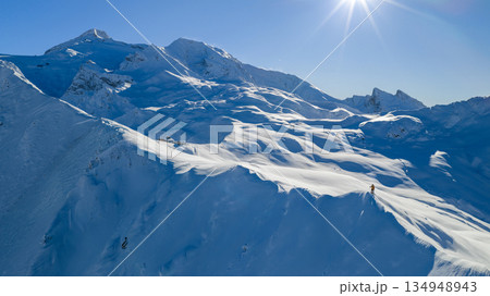 Panorama view of a snow-covered high mountains in Austria Alps with ski mountaineer 134948943