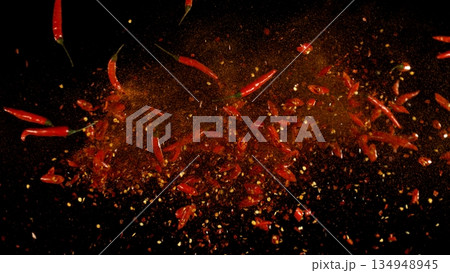 Freeze Motion Shot of Flying Red Chili Peppers Isolated on Black Background 134948945
