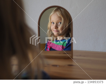 Child Observing Reflection in Mirror with a Smile Child Observing Reflection in Mirror with a Smile 134953373