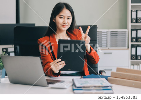 Beautiful young woman working using touchpad tablet 134953383