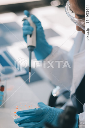 Portrait, science and happy woman on laptop in lab to research chemistry, test or innovation. Microscope, scientist and face of medical doctor in goggles for microbiology, healthcare or pharma study 134953444