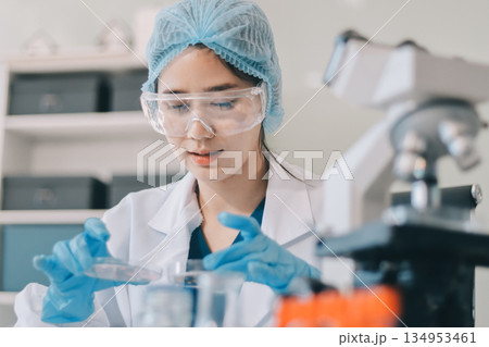Portrait, science and happy woman on laptop in lab to research chemistry, test or innovation. Microscope, scientist and face of medical doctor in goggles for microbiology, healthcare or pharma study 134953461