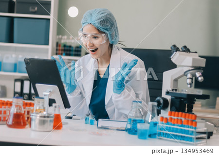 Portrait, science and happy woman on laptop in lab to research chemistry, test or innovation. Microscope, scientist and face of medical doctor in goggles for microbiology, healthcare or pharma study 134953469
