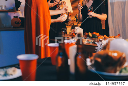 Friends enjoying a Halloween party at a bar making a toast 134957767