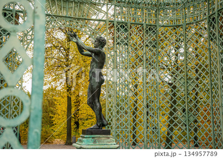 statue in Openwork metal gazebo in Sanssouci Park in Potsdam, Germany statue in Openwork metal gazebo in Sanssouci Park in Potsdam, Germany 134957789