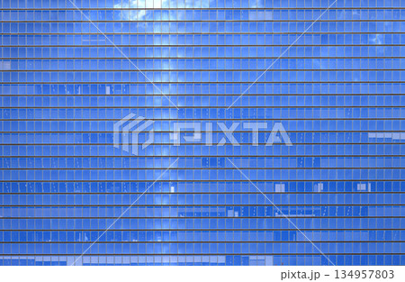 Glass wall of the office building, modern glass building, skyscrapers with clear sky background. Glass wall of the office building, modern glass building, skyscrapers with clear sky background. 134957803