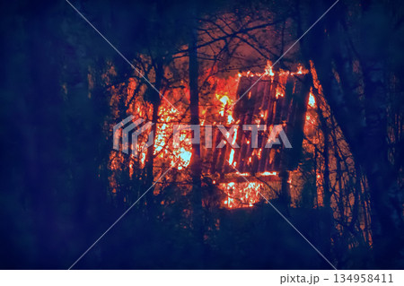 small wooden cottage on fire at night small wooden cottage on fire at night 134958411