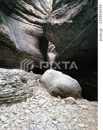 A large rock sits in a rocky canyon 134958454