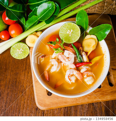 A bowl of soup with shrimp and lime A bowl of soup with shrimp and lime 134958456