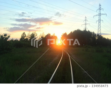A train track with a sun in the sky 134958473