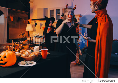 Friends enjoying a Halloween party at a bar making a toast Friends enjoying a Halloween party at a bar making a toast 134958504