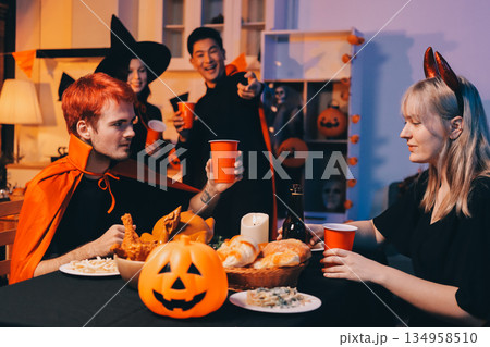 Friends enjoying a Halloween party at a bar making a toast Friends enjoying a Halloween party at a bar making a toast 134958510