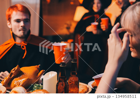 Friends enjoying a Halloween party at a bar making a toast Friends enjoying a Halloween party at a bar making a toast 134958511