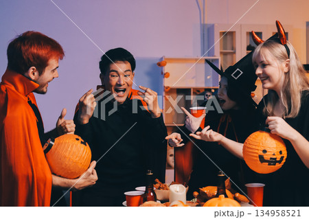 Friends enjoying a Halloween party at a bar making a toast 134958521
