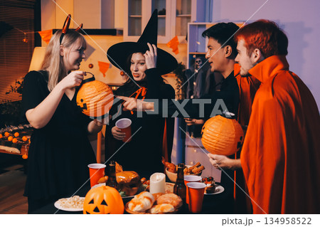 Friends enjoying a Halloween party at a bar making a toast 134958522