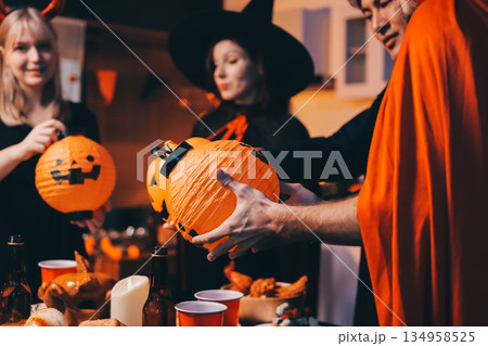 Friends enjoying a Halloween party at a bar making a toast 134958525