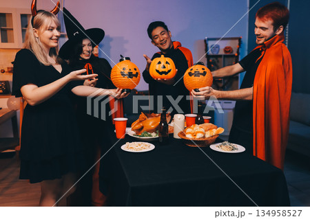 Friends enjoying a Halloween party at a bar making a toast Friends enjoying a Halloween party at a bar making a toast 134958527