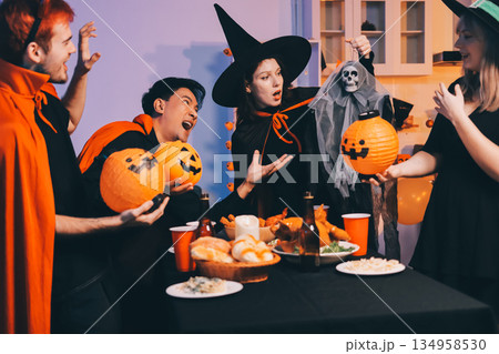 Friends enjoying a Halloween party at a bar making a toast 134958530