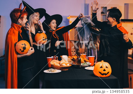 Friends enjoying a Halloween party at a bar making a toast Friends enjoying a Halloween party at a bar making a toast 134958535