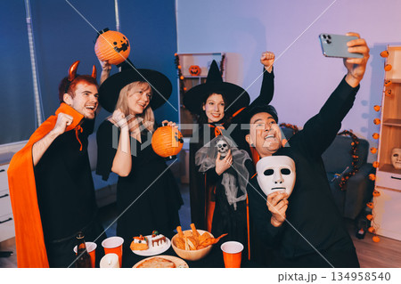 Friends enjoying a Halloween party at a bar making a toast 134958540