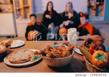 Friends enjoying a Halloween party at a bar making a toast 134958559