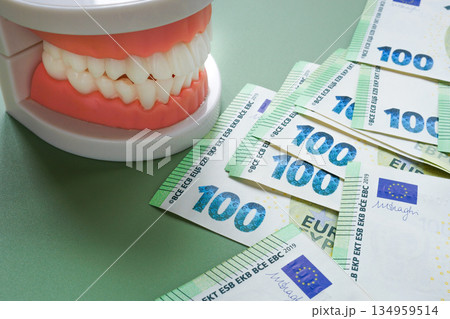 Dental insurance concept with jaw and euro banknotes. Healthcare costs. Dental insurance concept with jaw and euro banknotes. Healthcare costs. 134959514