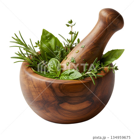 Aromatic herbs being crushed in a wooden mortar, representing homemade spice blends, natural flavors, and artisanal cooking 134959675