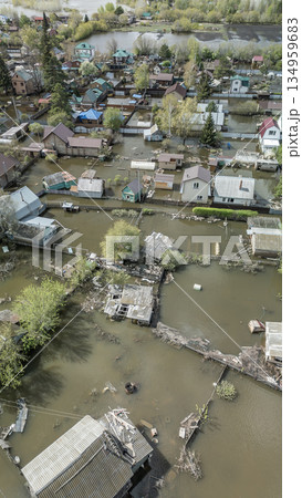 Aerial drone footage of a massive city flood with houses and streets submerged under water. Urban flooding caused by extreme weather and heavy rainfall, showing natural disaster impact on residential Aerial drone footage of a massive city flood with houses and streets submerged under water. Urban flooding caused by extreme weather and heavy rainfall, showing natural disaster impact on residential 134959683