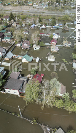 Aerial drone footage of a massive city flood with houses and streets submerged under water. Urban flooding caused by extreme weather and heavy rainfall, showing natural disaster impact on residential Aerial drone footage of a massive city flood with houses and streets submerged under water. Urban flooding caused by extreme weather and heavy rainfall, showing natural disaster impact on residential 134959685