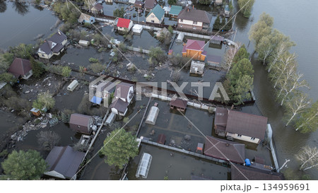 Aerial drone footage of a massive city flood with houses and streets submerged under water. Urban flooding caused by extreme weather and heavy rainfall, showing natural disaster impact on residential Aerial drone footage of a massive city flood with houses and streets submerged under water. Urban flooding caused by extreme weather and heavy rainfall, showing natural disaster impact on residential 134959691