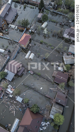 Aerial drone footage of a massive city flood with houses and streets submerged under water. Urban flooding caused by extreme weather and heavy rainfall, showing natural disaster impact on residential Aerial drone footage of a massive city flood with houses and streets submerged under water. Urban flooding caused by extreme weather and heavy rainfall, showing natural disaster impact on residential 134959692