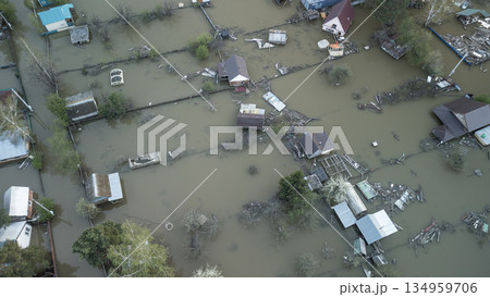Aerial drone footage of a massive city flood with houses and streets submerged under water. Urban flooding caused by extreme weather and heavy rainfall, showing natural disaster impact on residential Aerial drone footage of a massive city flood with houses and streets submerged under water. Urban flooding caused by extreme weather and heavy rainfall, showing natural disaster impact on residential 134959706