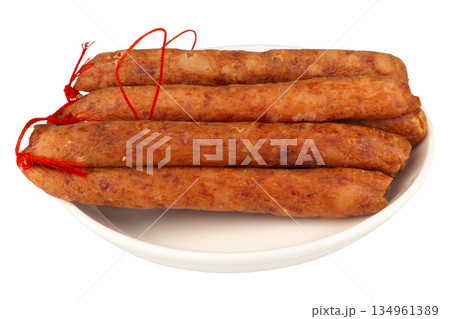 Thai pork sausage on a white plate against a white background Thai pork sausage on a white plate against a white background 134961389