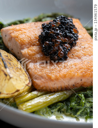Grilled salmon with black caviar garnish 134961579