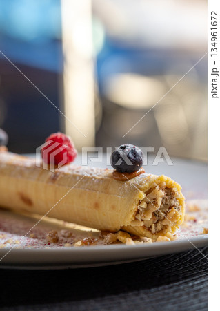 Rolled dessert with fresh berries and nuts 134961672