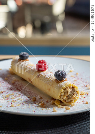 Rolled wafer dessert with fresh berries 134961675