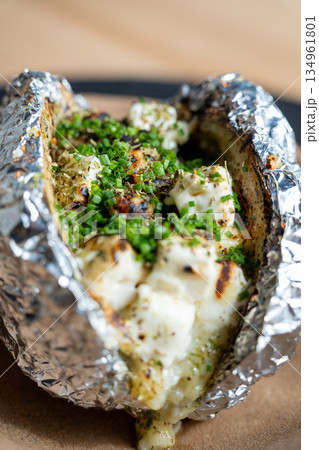 Baked potato with chives in foil Baked potato with chives in foil 134961801