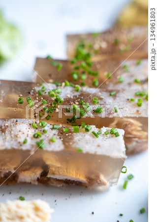 Closeup of aspic with chopped herbs 134961803