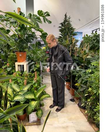 Person shopping in indoor plant section 134961886