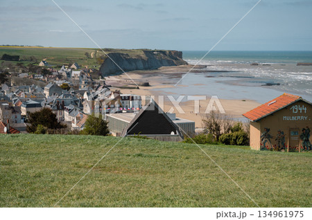 A wide scenic view of Arromanches-les-Bains, France, showcasing the town and its historic beach. This D-Day landing site is now a peaceful coastal destination rich with World War II history. 134961975