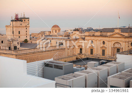A stunning aerial view of Valletta's rooftops, showcasing the city's historic architecture, domes, and limestone buildings under the Mediterranean sky. 134961981