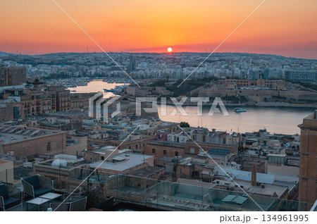 A stunning aerial view of Valletta's rooftops, showcasing the city's historic architecture, domes, and limestone buildings under the Mediterranean sky. 134961995